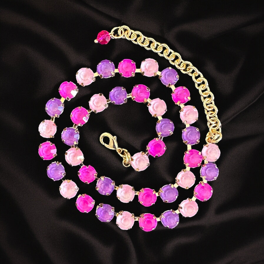 Vibrant gemstone necklace featuring a stunning combination of purple and pink crystals, perfect for adding a touch of bohemian flair to any outfit.

