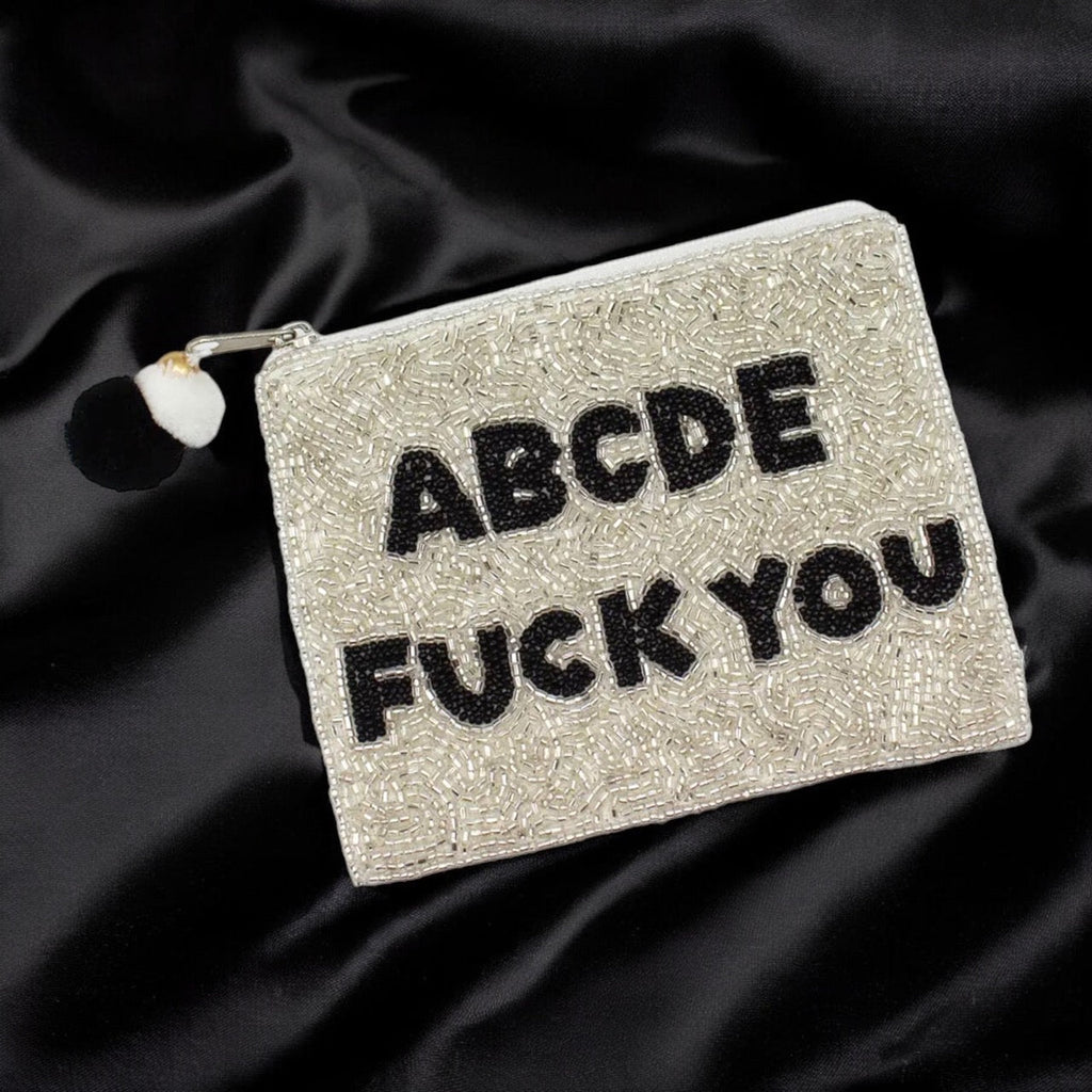 Close-up of a beaded clutch bag with funny text