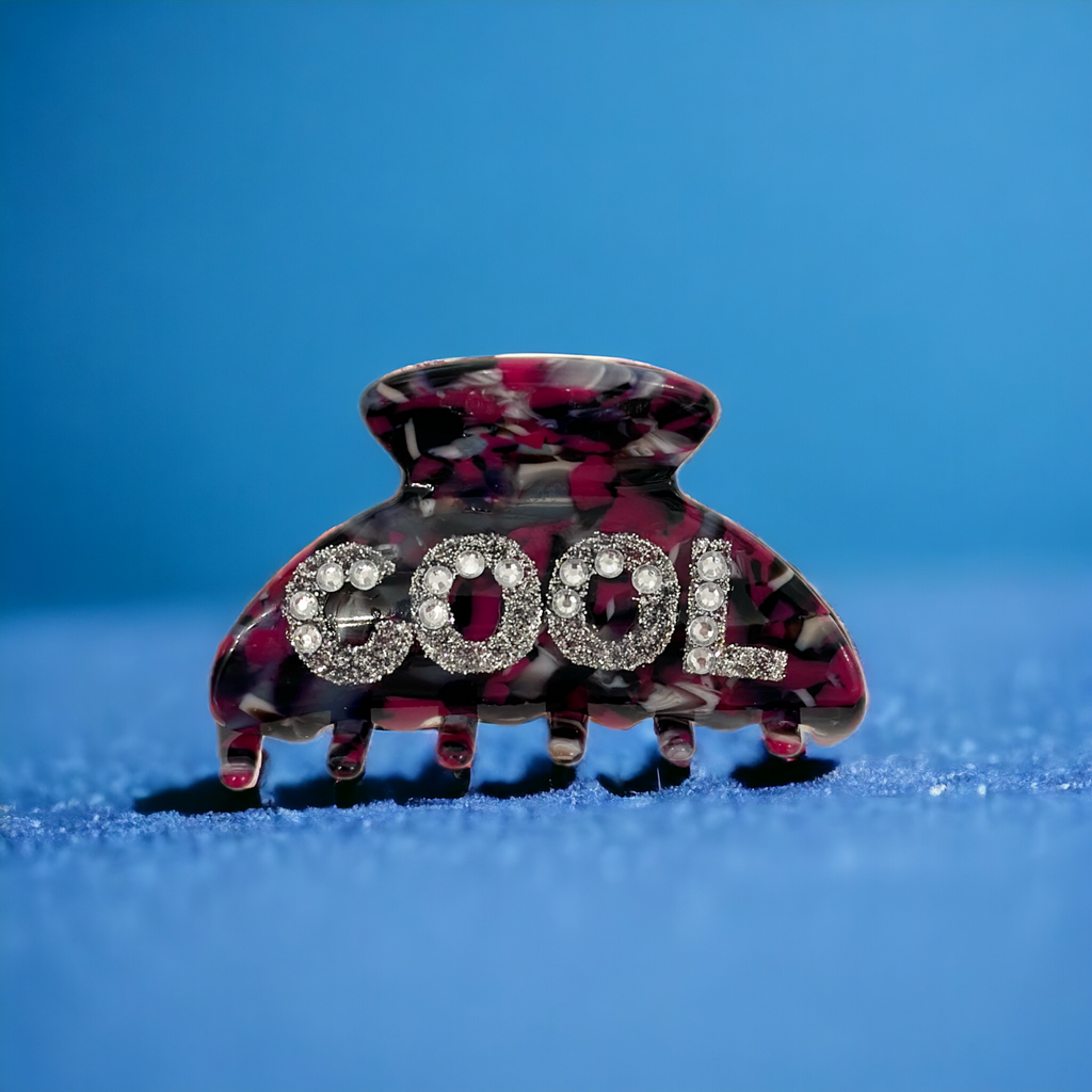 Stylish rhinestone-embellished hair clip with "COOL" lettering, a chic addition to any hairstyle.