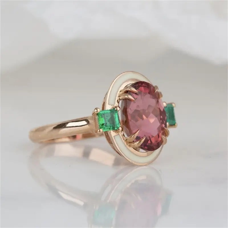 Bold costume jewelry ring with rose tourmaline and emerald accents in gold-tone.