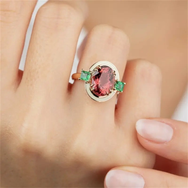 Lightweight gold-tone costume ring with rose tourmaline-inspired centerpiece.