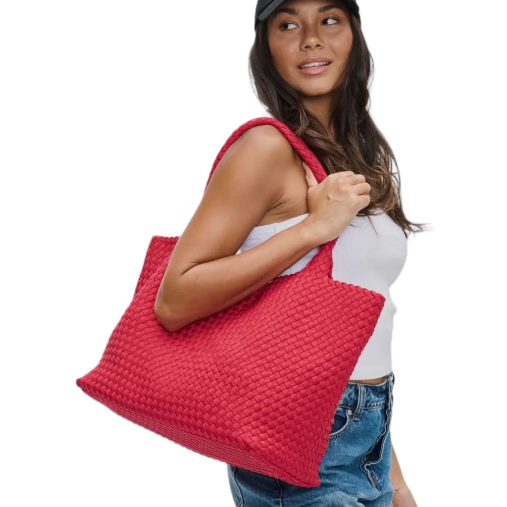 Large red tote with a basketweave texture, ideal for carrying essentials for beach trips or everyday use.