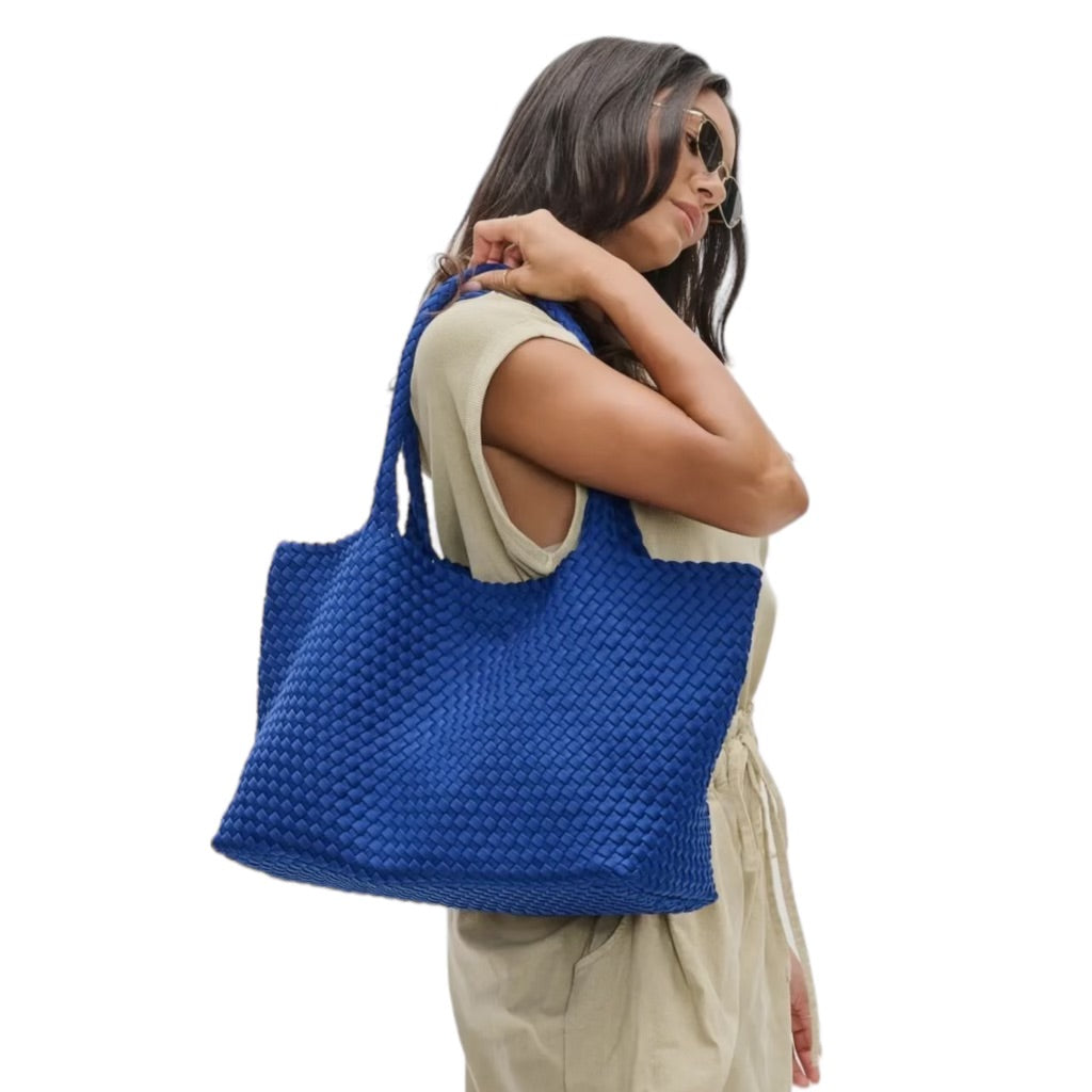 Versatile blue tote bag with a unique basketweave design, ideal for beach or park outings.