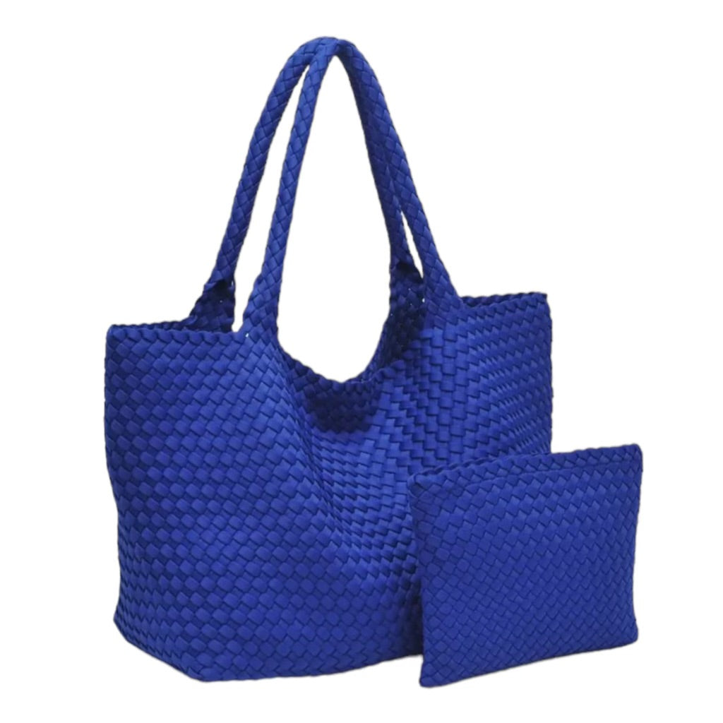 Blue basketweave tote bag with a spacious interior, perfect for beach days or picnics.