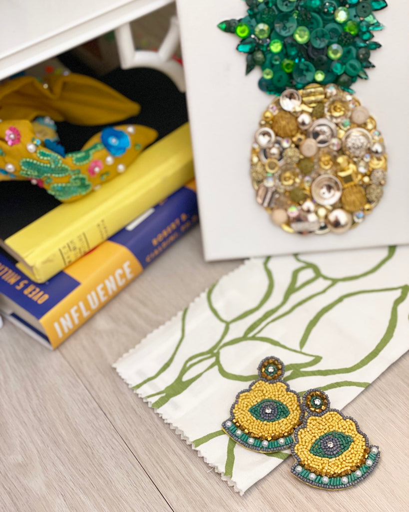 Mystical Misfit Earrings with bold yellow and green colors, featuring a unique beaded design and artistic patch detail.