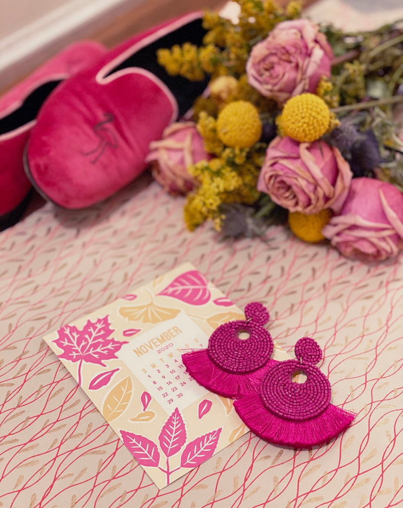 Vibrant fuchsia statement earrings with beaded fringe and a playful patch design, ideal for stylish, expressive looks.