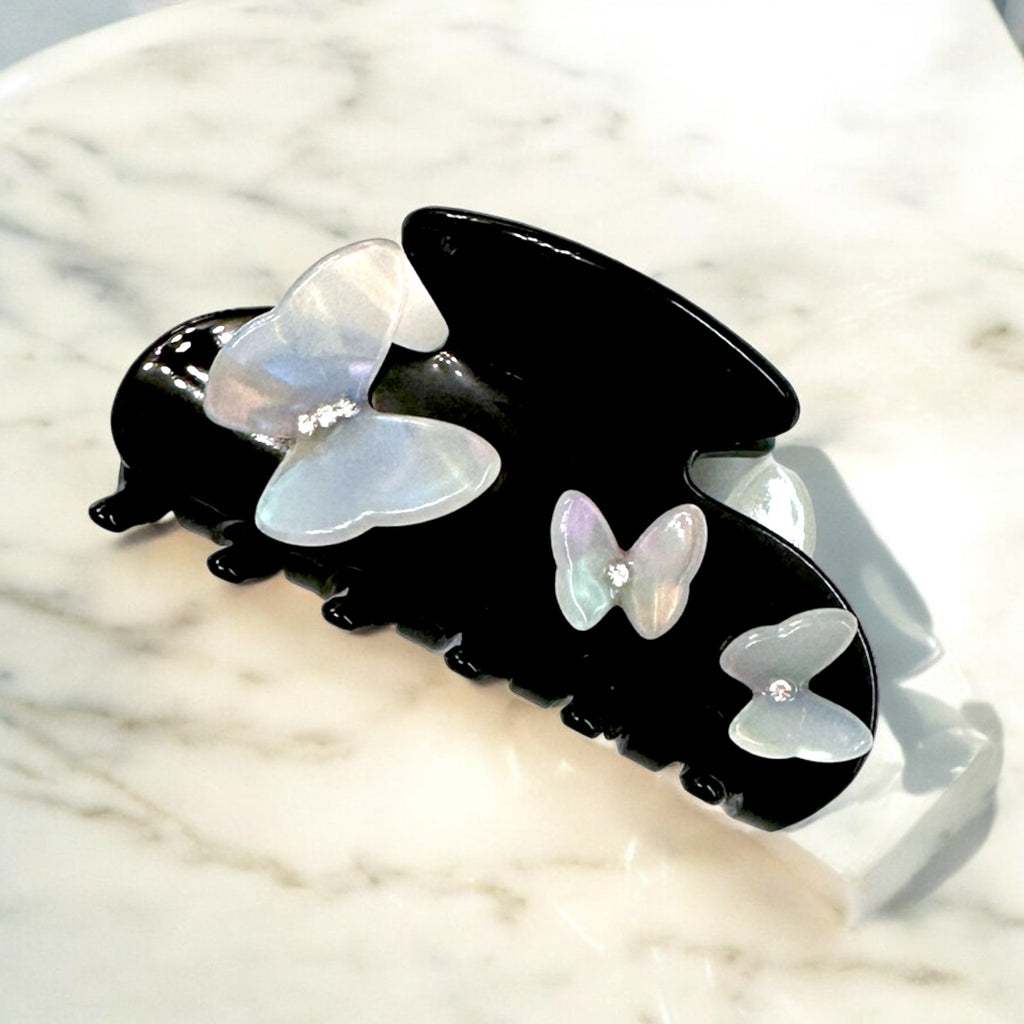 Elegant butterfly design hair clip in black with decorative pearl details for women.