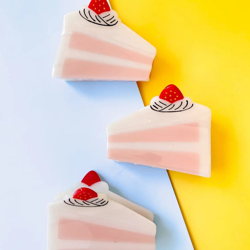 Adorable cake slice hair clip with strawberry topping.