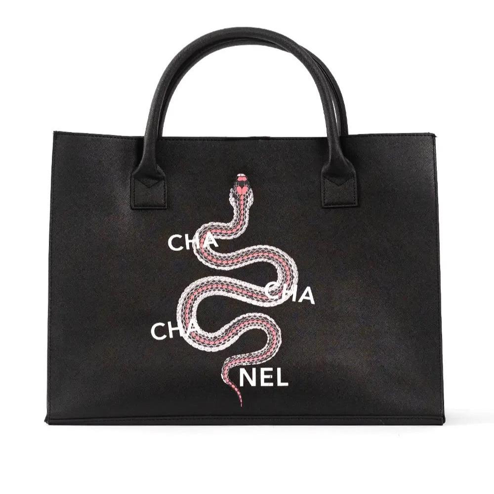 Black vegan leather tote with a stylish snake design and magnetic clasp, perfect for carrying daily essentials.