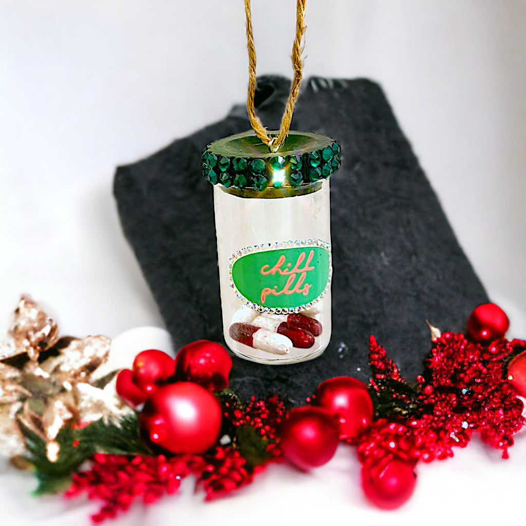 Bottled "Chill Pills" ornament made from glass, featuring a playful design perfect for adding humor to your holiday decor.