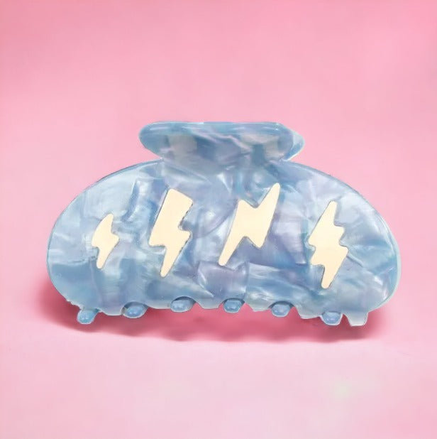 Cute blue hair clip with white thunderbolt design.