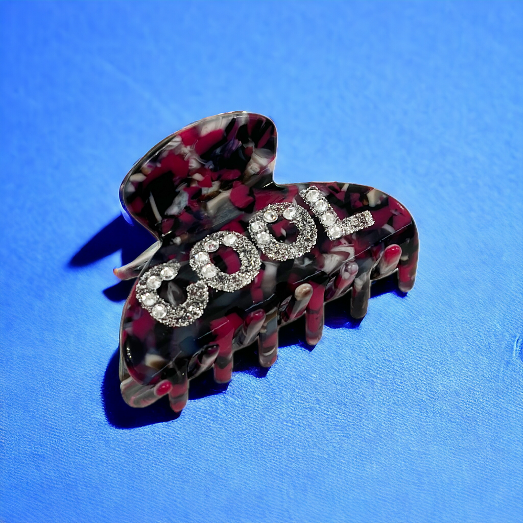 Acetate hair clip with cool rhinestone lettering, small and subtle for versatile styling.