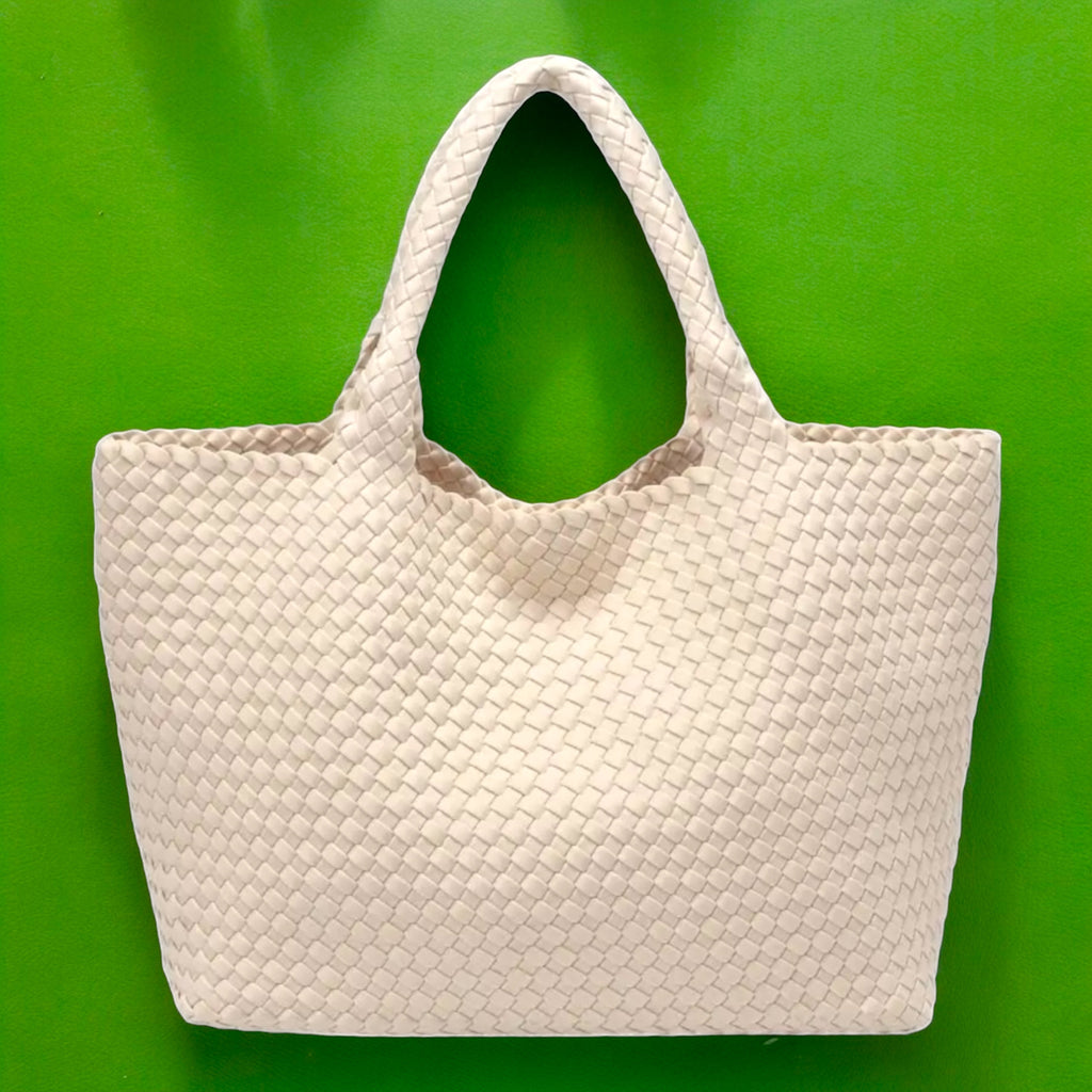 Fashionable ivory tote bag with a distinctive basketweave design, perfect for adding a chic touch to any outfit.