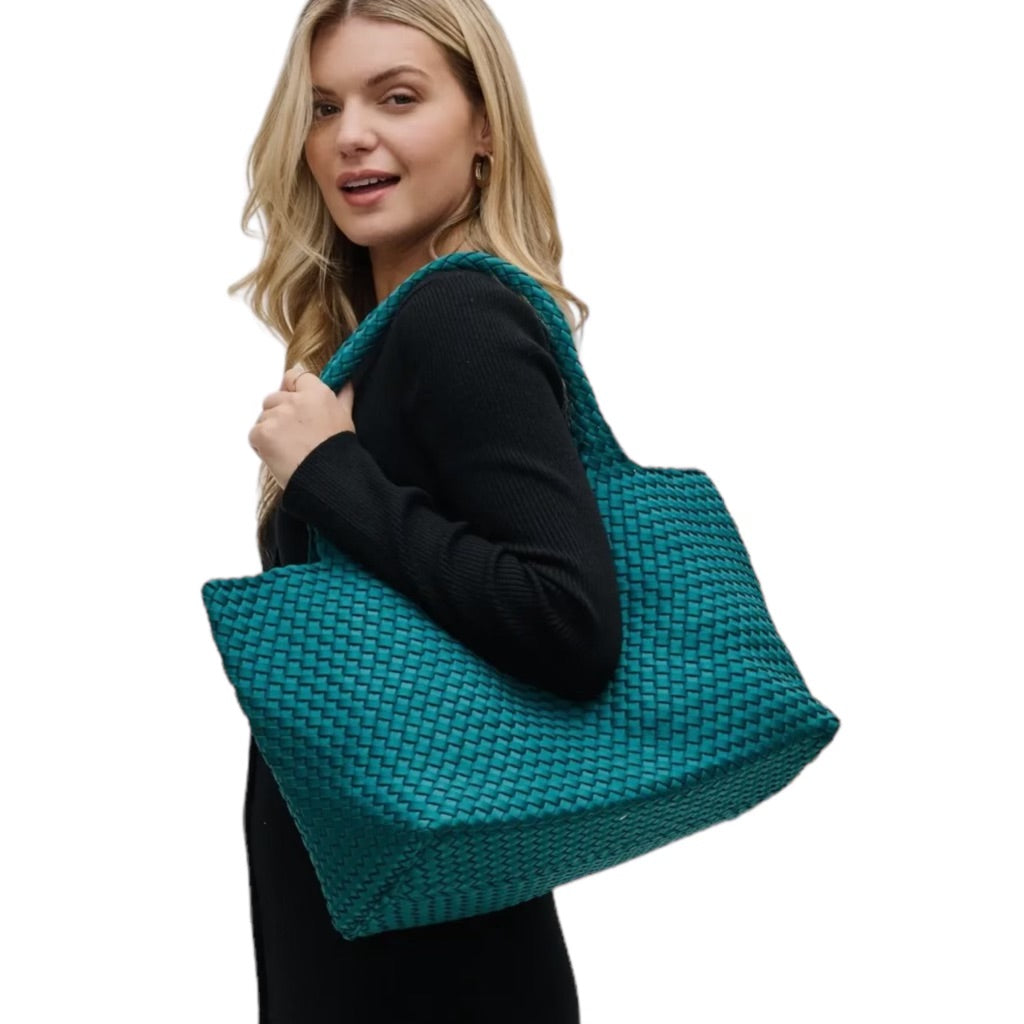 Fashionable teal tote featuring a basketweave design, water-resistant neoprene material, and spacious interior for all your essentials.