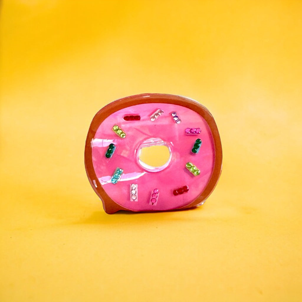 Hot pink donut hair clip with a sprinkle embellishment.
