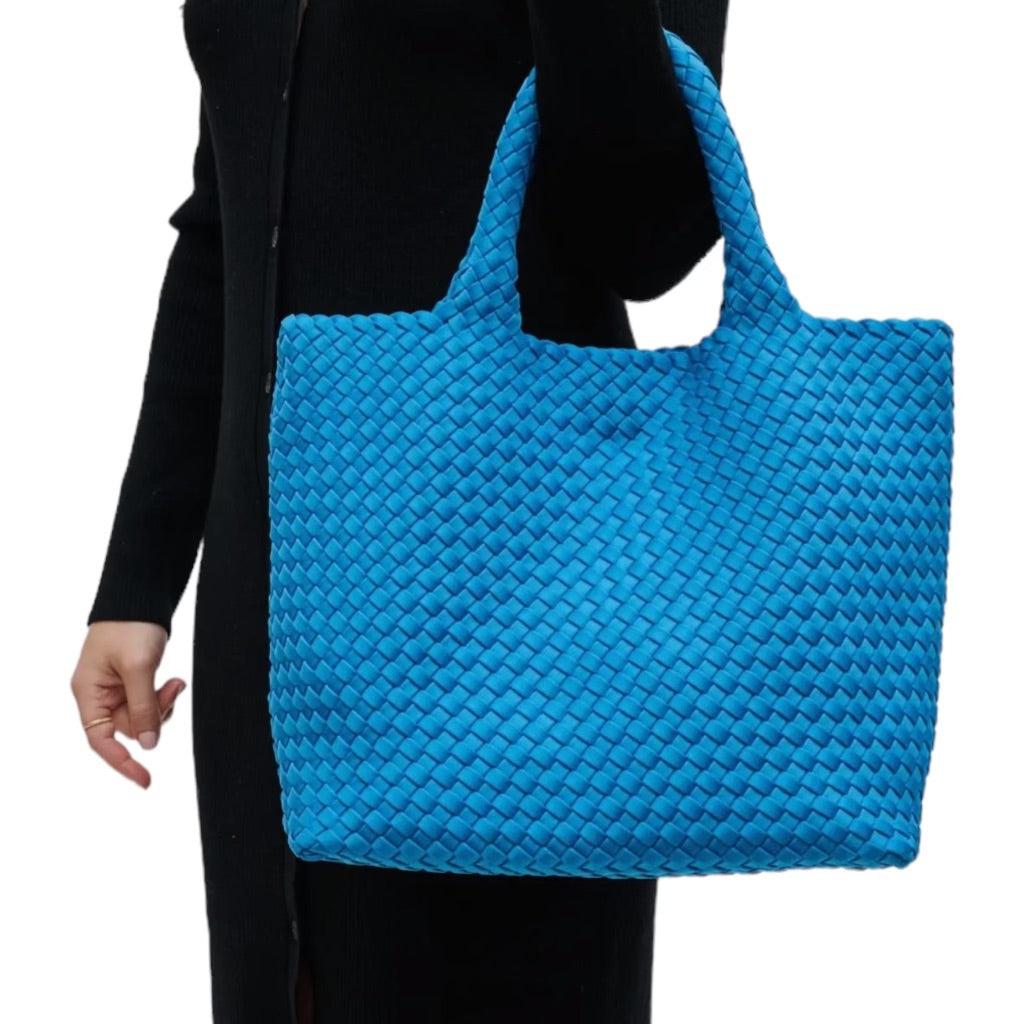 Aqua tote with distinctive basketweave design, made from durable neoprene, perfect for adding a playful touch to any outfit.