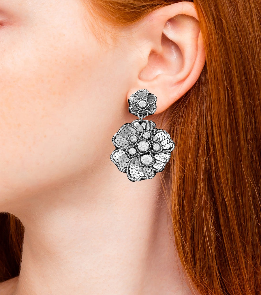 Metallic floral earrings with eye-catching "WTF" patches, perfect for standing out with a playful and chic accessory.