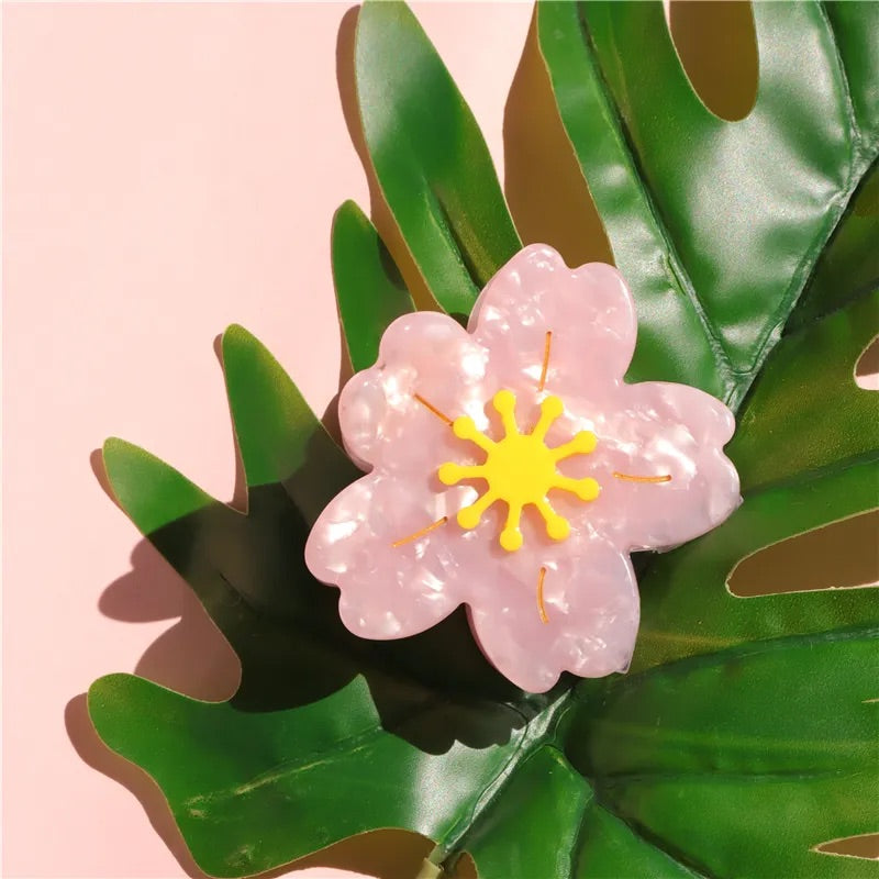 Stylish pink flower hair clip, designed to enhance any hairstyle with a chic, spring-ready look.