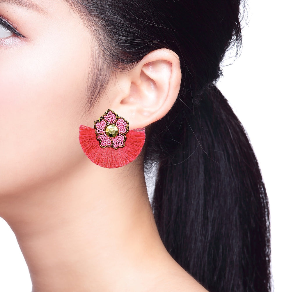 Vibrant fuchsia statement earrings with a handmade floral and patch detail, perfect for spring fashion.