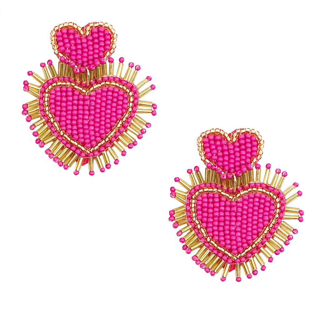 Vibrant pink and gold earrings featuring a unique double heart design and quirky "Happy Leaves" patch, ideal for standing out.