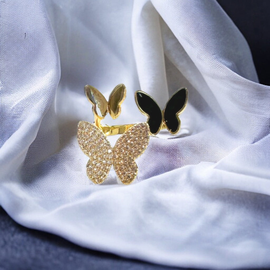 Three elegant butterflies, their wings adorned with intricate patterns, flutter around an openwork ring, creating a captivating and ethereal accessory for any jewelry enthusiast. (1