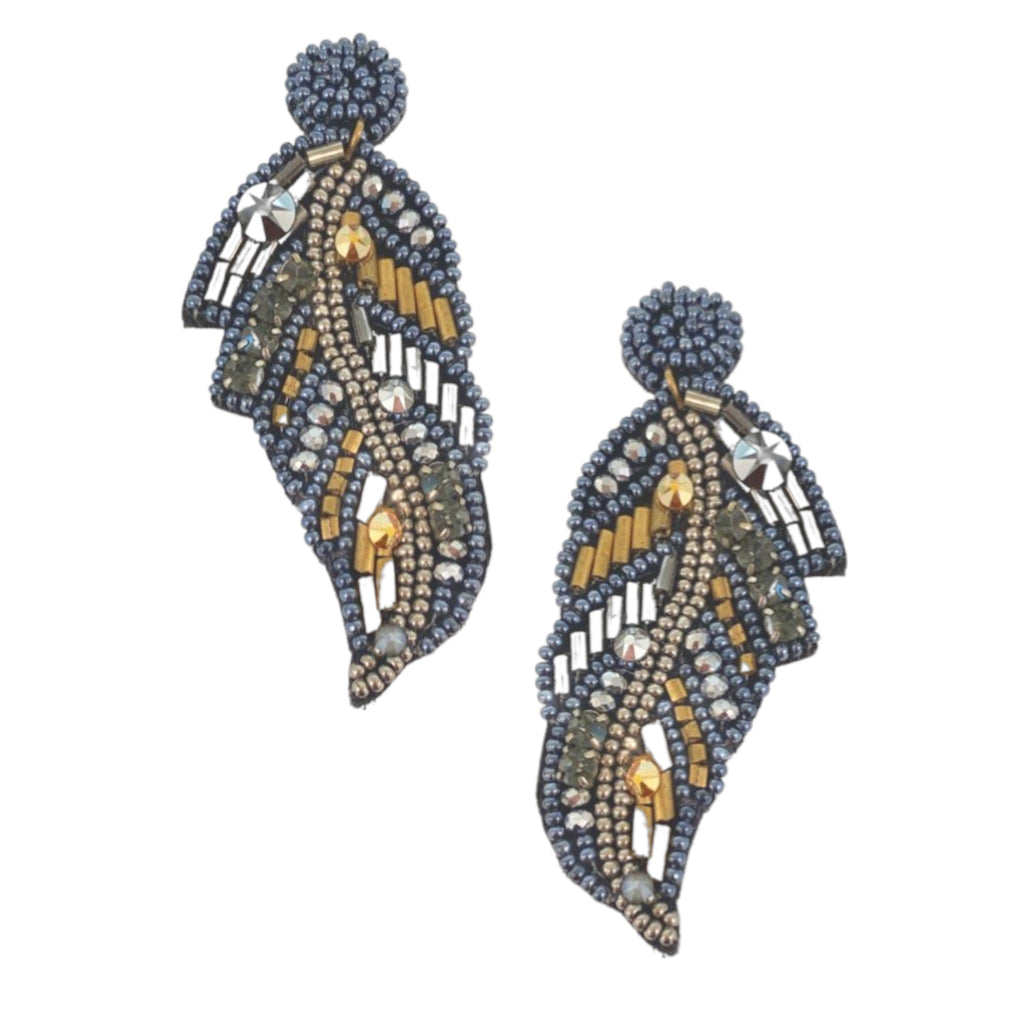 Unique asymmetrical earrings featuring gilded feathers and playful patches for a bold statement.