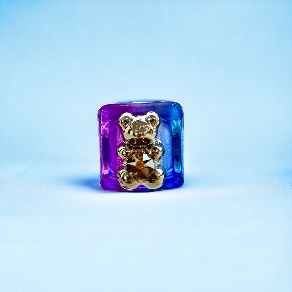  Brightly colored purple gummy bear ring adds a subtle pop of color, making it the perfect accessory to add to your daily jewelry rotation. The soft silicone feels comfortable on the fingers and can be dressed up or down for any occasion. 
