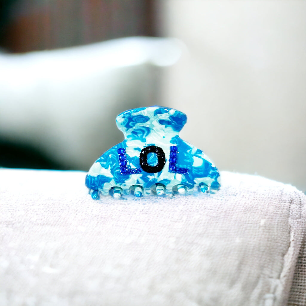 Stylish blue hair clip featuring rhinestones spelling out LOL, perfect for statement-making.