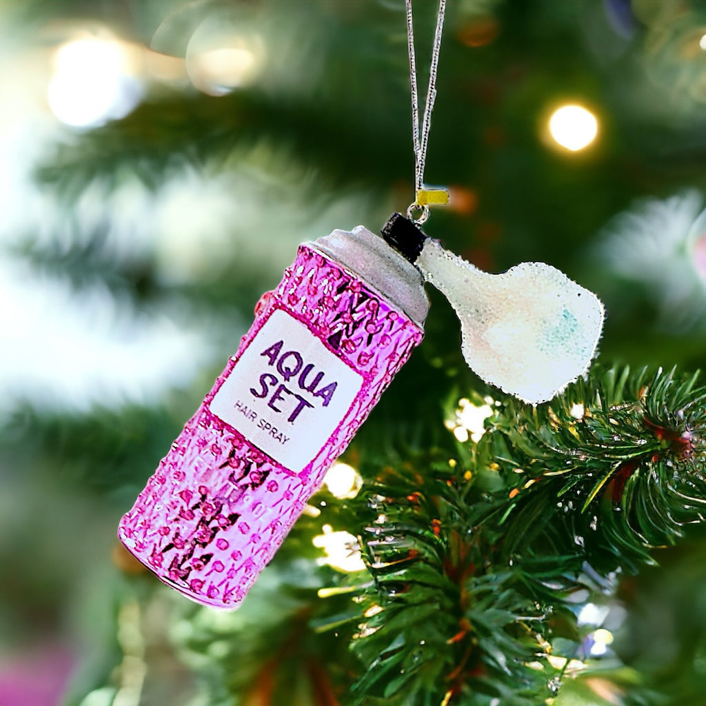 Pink retro hairspray bottle ornament with a glitter finish, perfect for adding a fun and nostalgic touch to your holiday decorations.