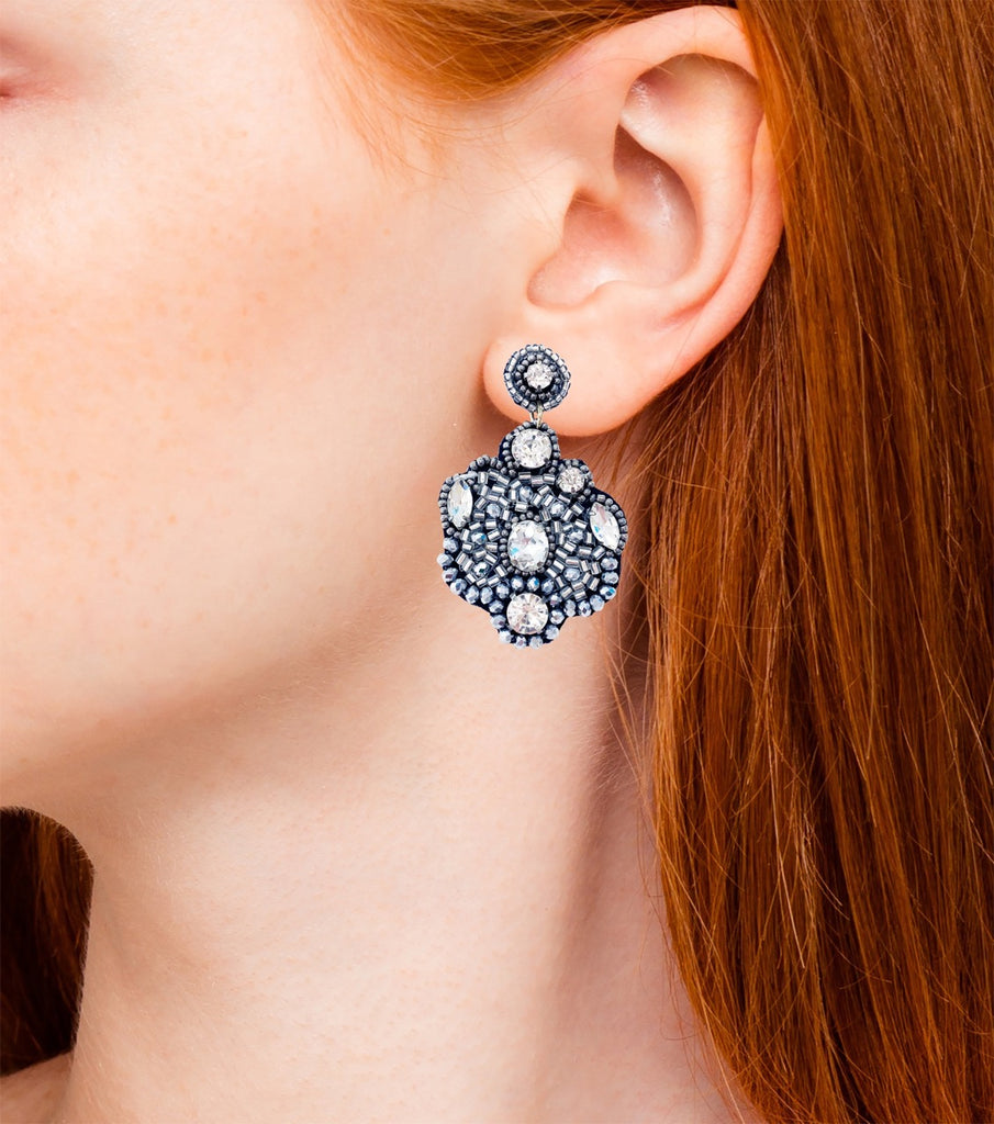 Elegant silver earrings with high-shine and shimmer, adorned with a monkey-themed patch for a playful fashion statement.