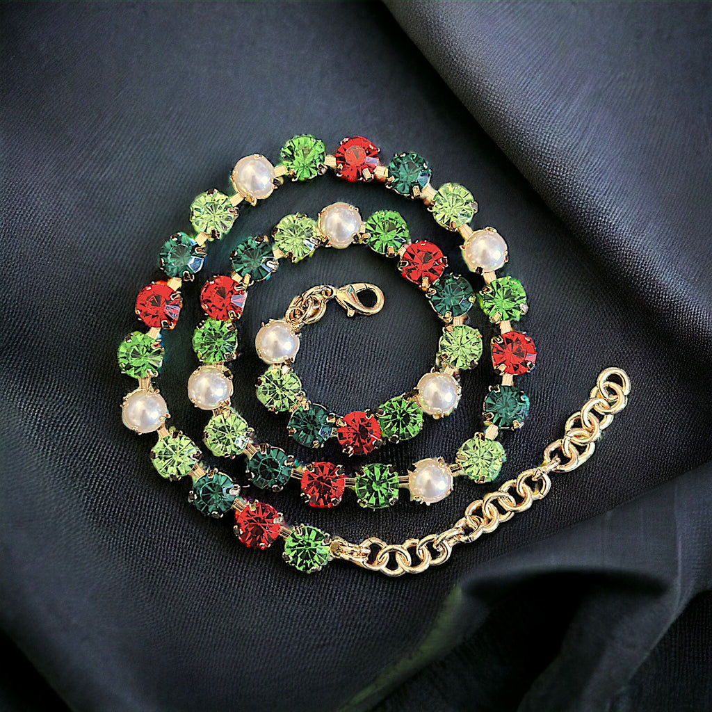 Elegant festive necklace with red, green, and pearl gemstones on a gold chain.