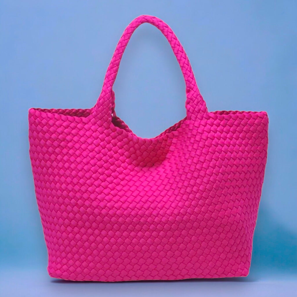 Fashionable pink tote with a textured basketweave pattern, ideal for carrying belongings in style to the beach, park, or everyday use.