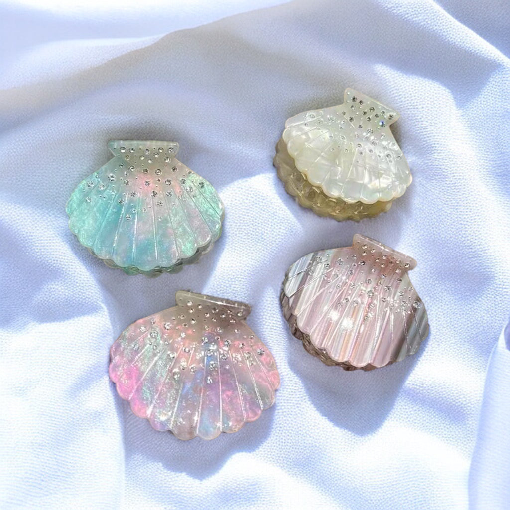 Shimmering pink seashell hair clip, a stylish and durable accessory for everyday wear.