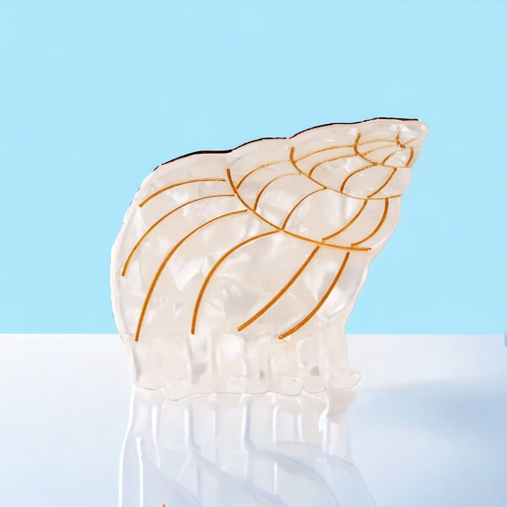 Playful ivory conch shell hair clip designed for stylish women and girls who love summer-inspired fashion.