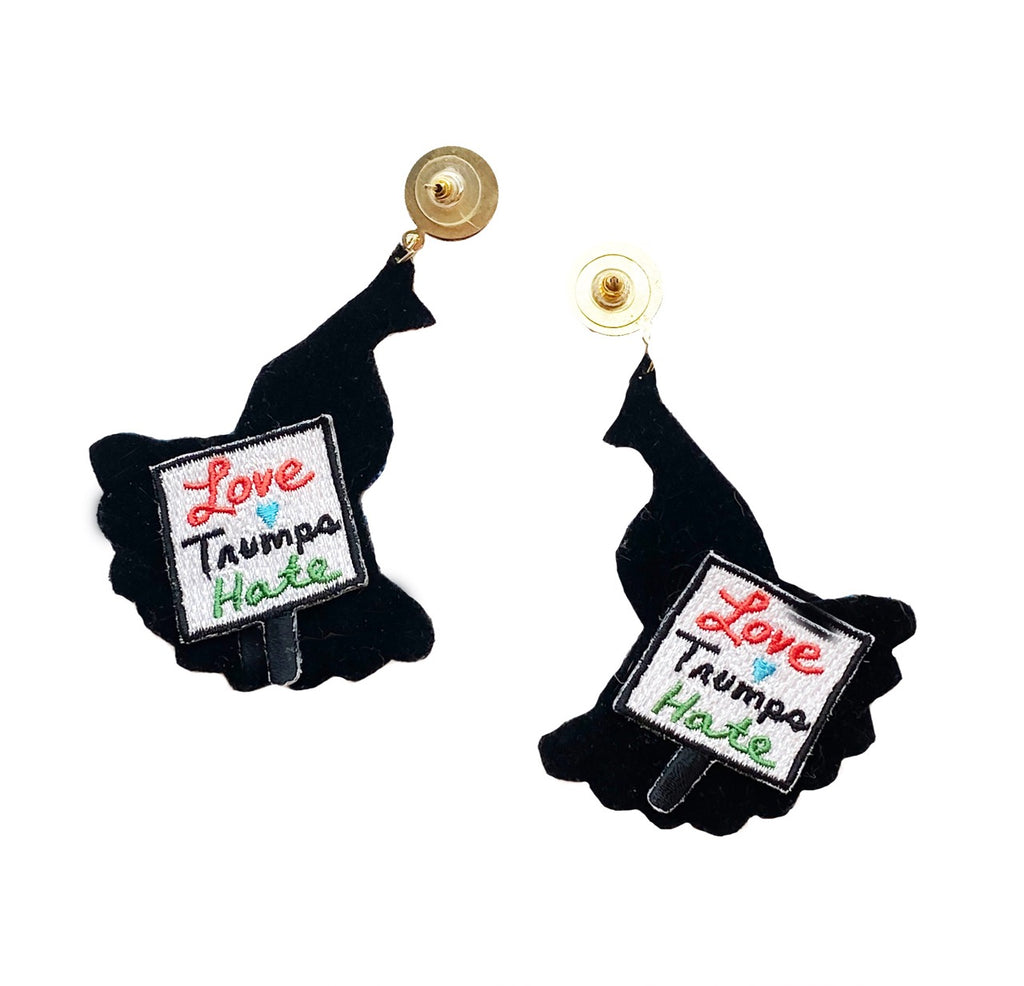 Handcrafted statement earrings featuring a peacock design with a "Love Trumps Hate" patch.