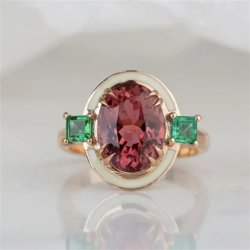 Faux rose tourmaline and emerald-inspired ring in a gold-tone finish, available in sizes 7 and 8.