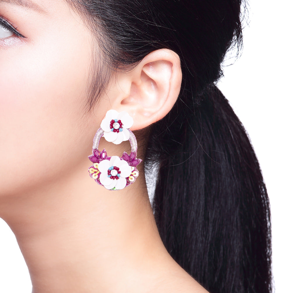 Magenta earrings with bold floral embroidery and playful patch details, lightweight and trendy.