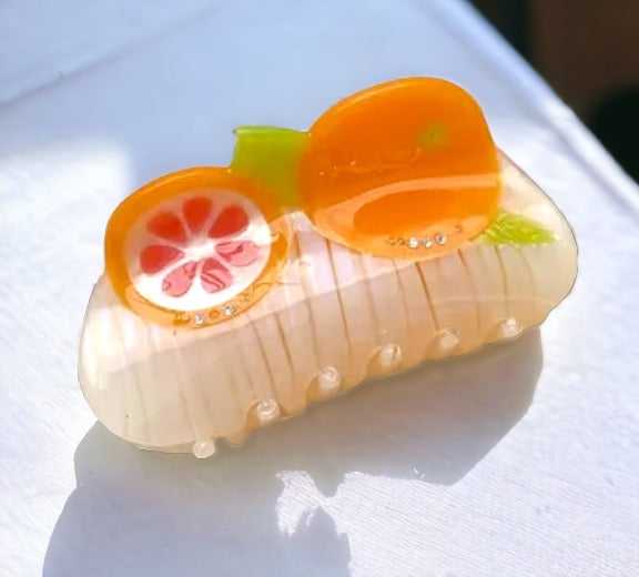 Fruity hair clip with an orange slice motif, adding a pop of color to your look.