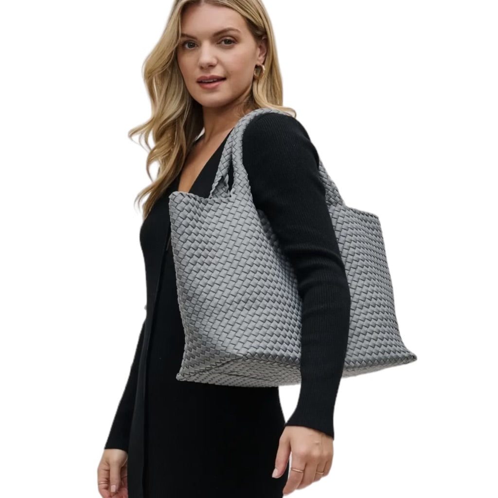 Grey basketweave tote with a large interior space, designed for versatile use, from the beach to casual outings.