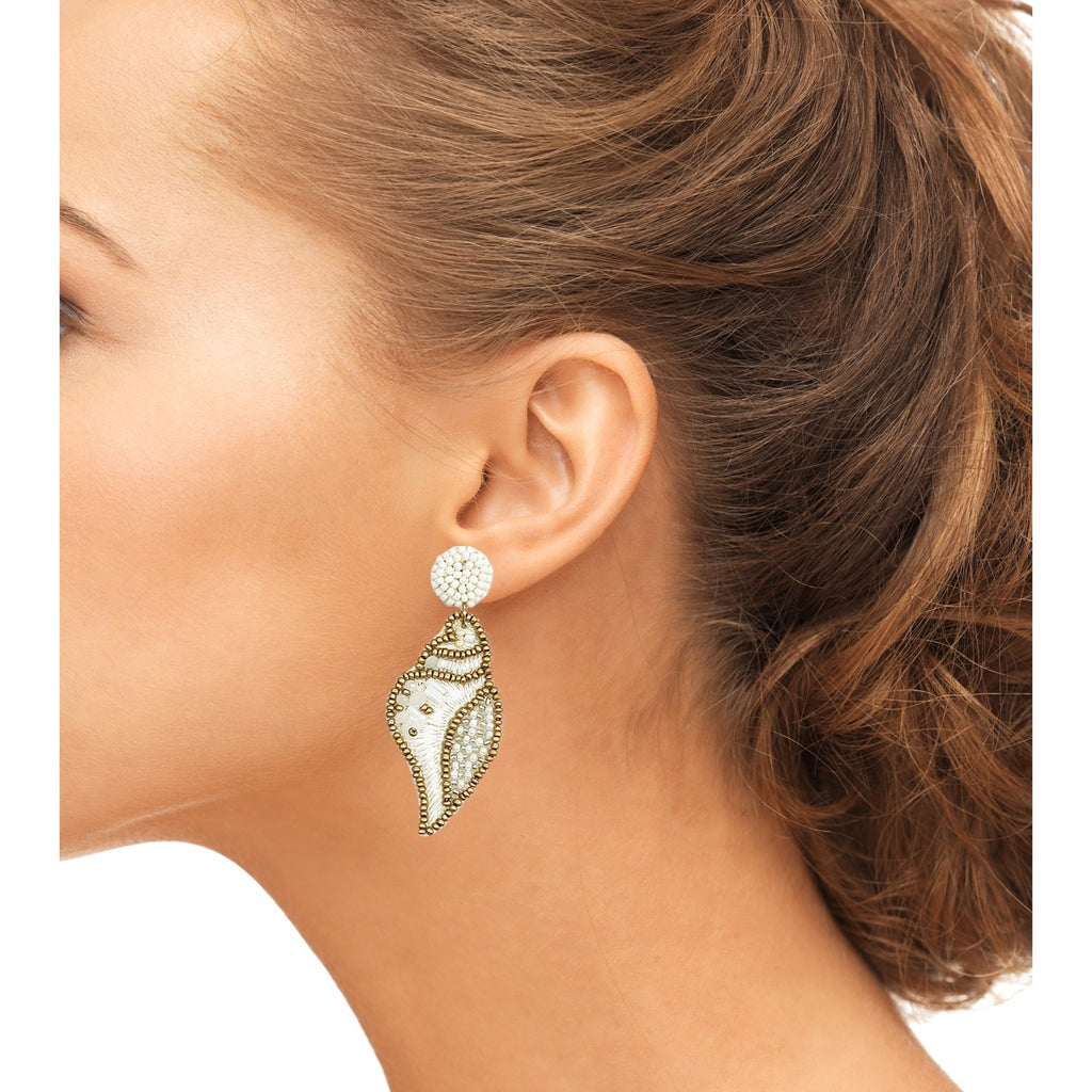 Ocean-inspired ivory earrings with beaded shell design and playful patches.