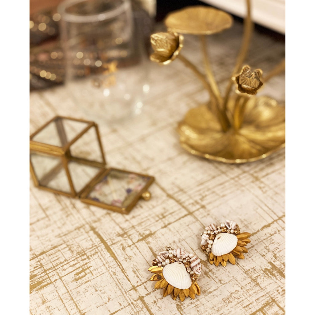 Ocean-themed gold earrings with a large oyster shell centerpiece, accented by rhinestones and gold leaf.