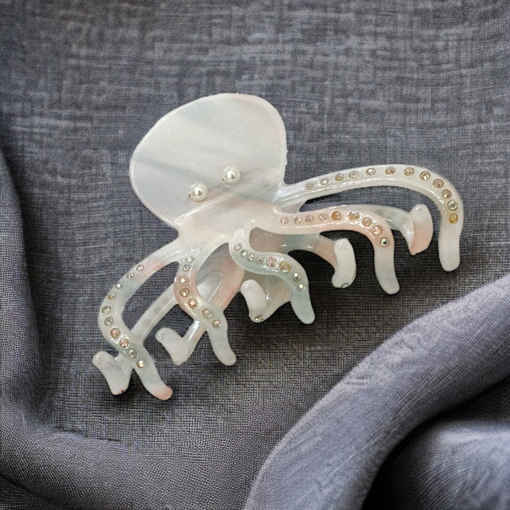 Shimmering white hair clip adorned with pearls and rhinestones, featuring an intricate octopus design for a unique and eye-catching accessory.