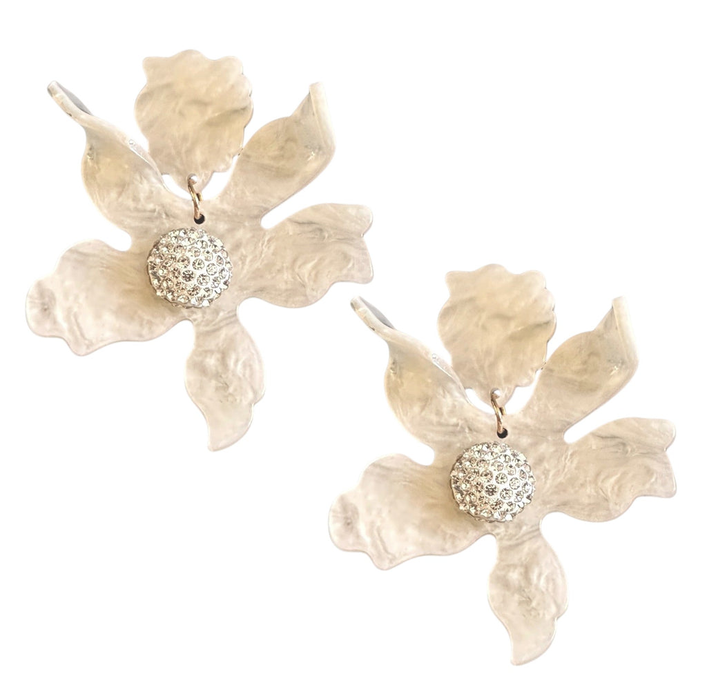 Delicate floral-inspired earrings with a textured ivory finish and a sparkling crystal centerpiece, perfect for adding a touch of elegance and sophistication to your look.