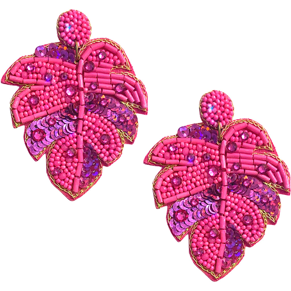 Statement pink earrings featuring a nature-inspired leaf design with Swarovski beading and a playful patch.