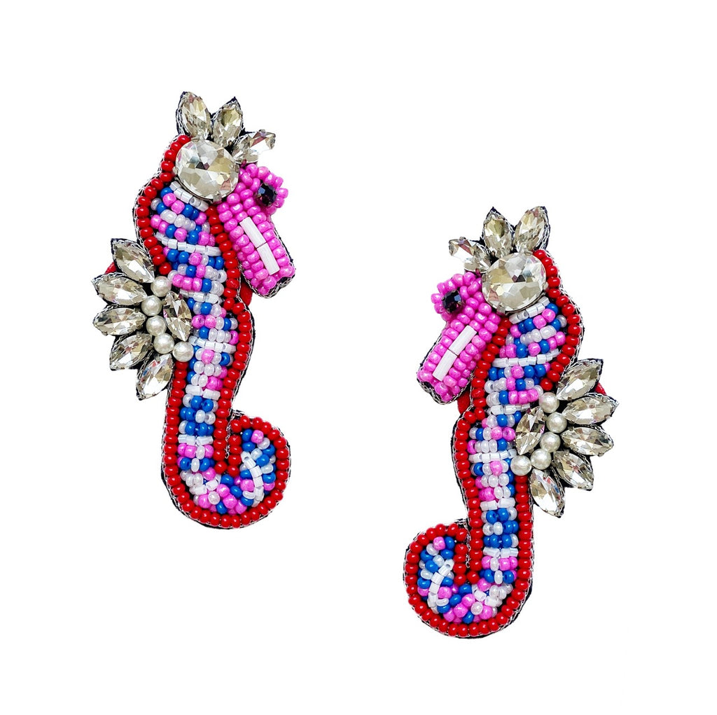 Vibrant pink and rhinestone seahorse earrings, perfect for adding a playful marine touch to your style.