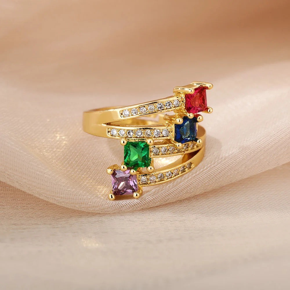 Gold ring with vibrant colored stones displayed