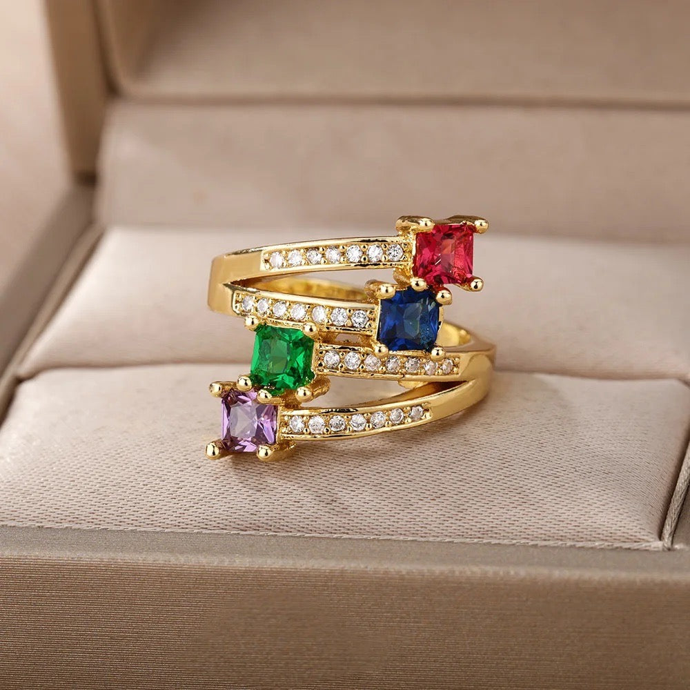 Close-up of a colorful gold ring with gemstones