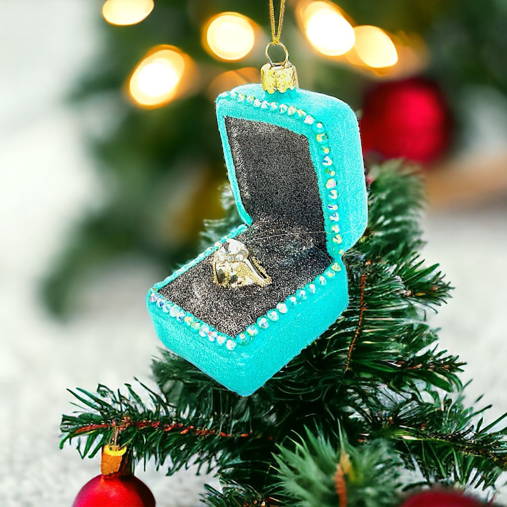 Glamorous diamond ring ornament in a detailed glass box, perfect for holiday decorating.