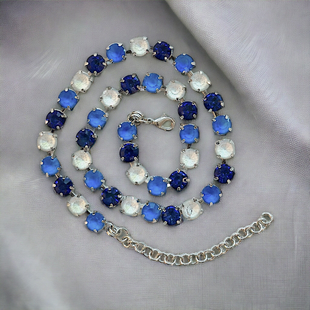 Stunning royal blue crystal necklace featuring an elegant pendant with intricate detailing, perfect for adding a touch of glamour to any outfit.
