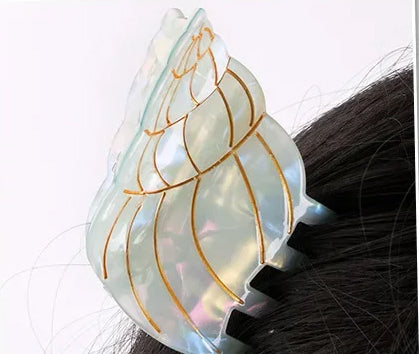 Playful blue conch shell hair clip designed for stylish women and girls who love summer-inspired fashion.